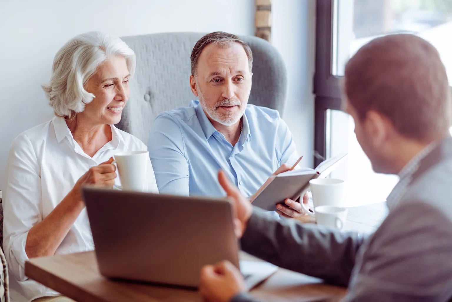 A senior couple getting their health insurance questions answered by an advisor