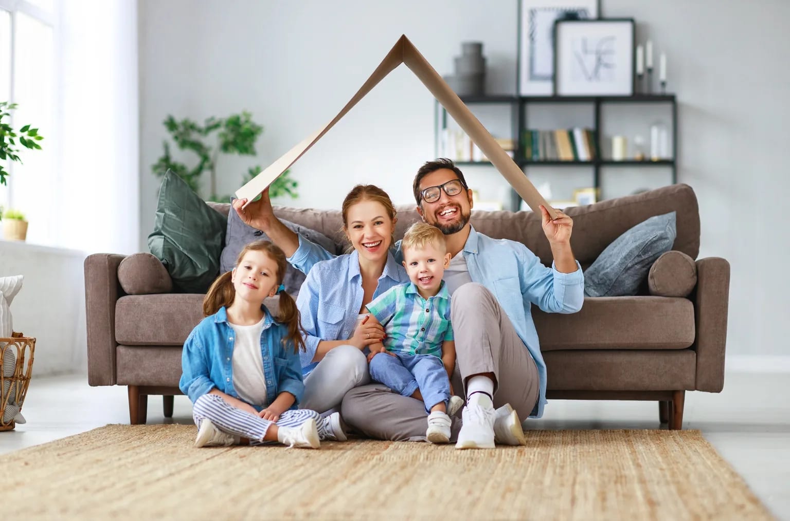 A happy family at home protected by health insurance coverage
