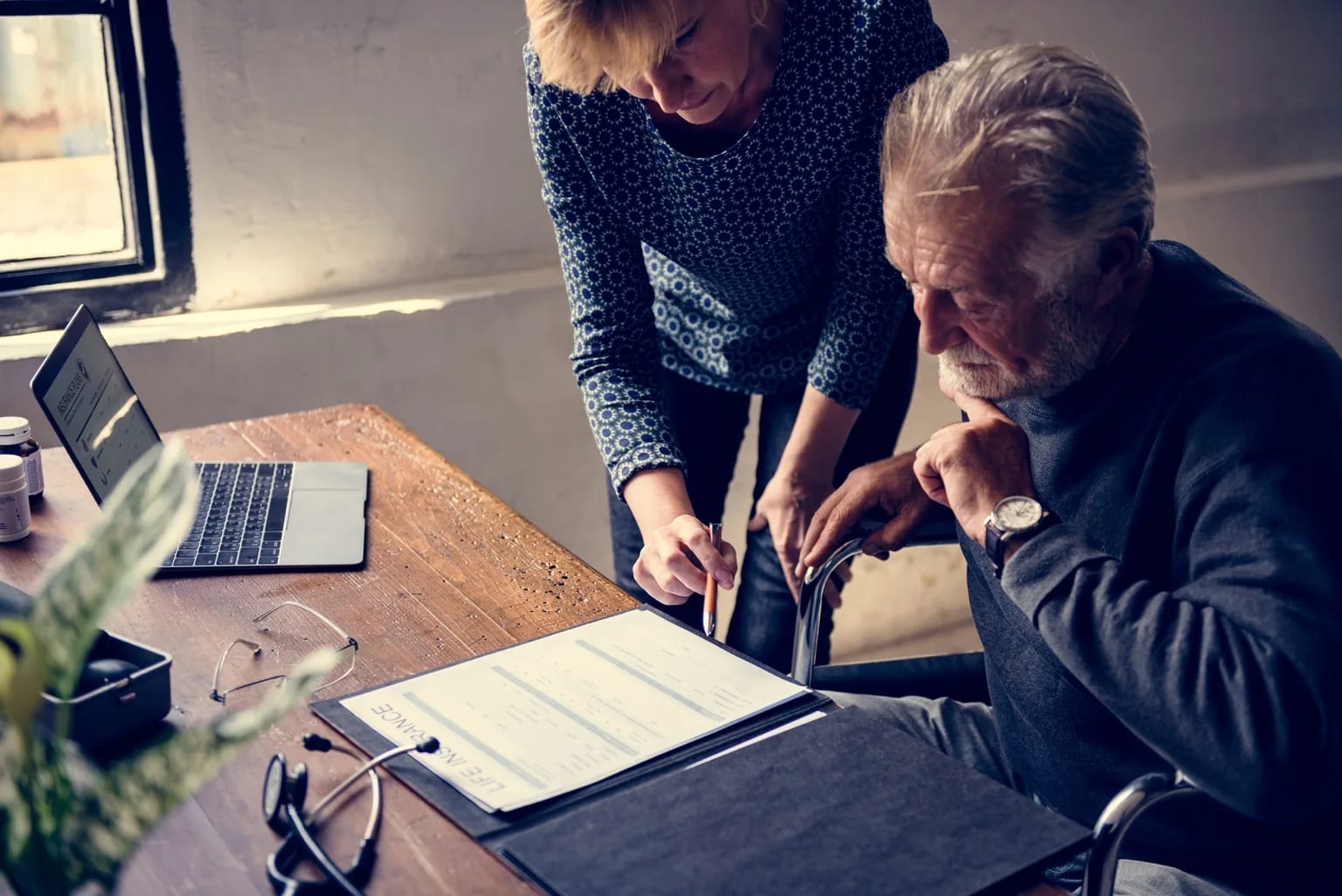 An advisor helping a client plan life insurance and retirement coverage